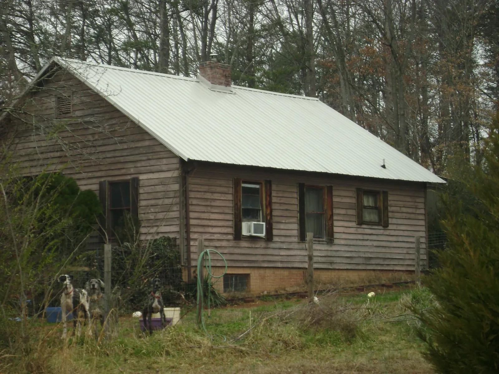 White metal roof on an old wood sided farmhouse, from a Metal Roof Installation job in Newfields
